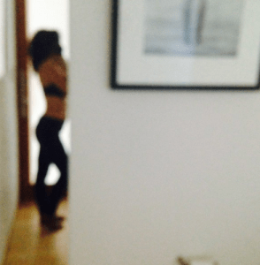 Mistress Blunt, yoga teacher and kink facilitator in the mirror