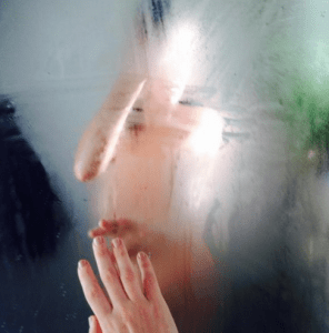 Mistress Blunt of NYC BDSM Dominatrix Yoga looks in the mirror